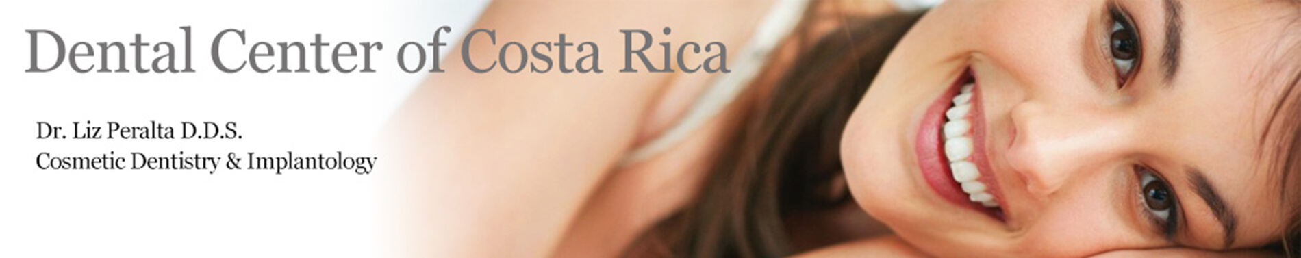 Banner featuring a portrait picture of a smiling woman with long brown hair happy with her Implantology procedure she had with the Dental Center of Costa Rica, San Jose, Costa Rica.