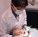 Picture of a male dentist performing dental work on a patient at the Dental Center of Costa Rica, San Jose, Costa Rica.